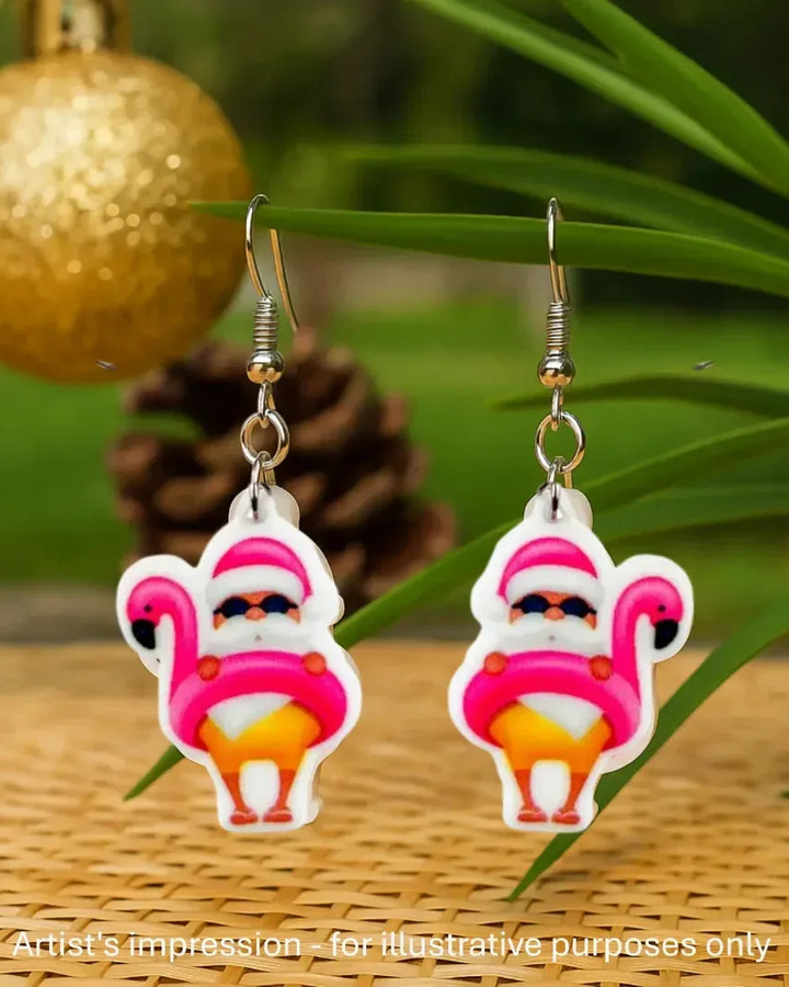 Flamingo floaty Santa Christmas earrings hanging beside a gold bauble and palm leaves