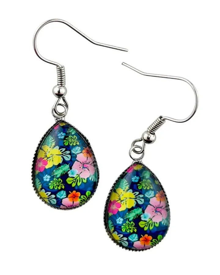 Close-up of floral teardrop drop earrings with glossy glass cabochon and silver hook fittings