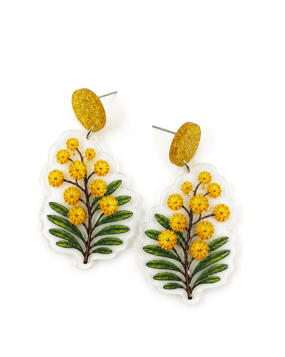 Golden wattle earrings with yellow pom-pom blooms and green leaves printed on clear acrylic, on gold glitter stud tops