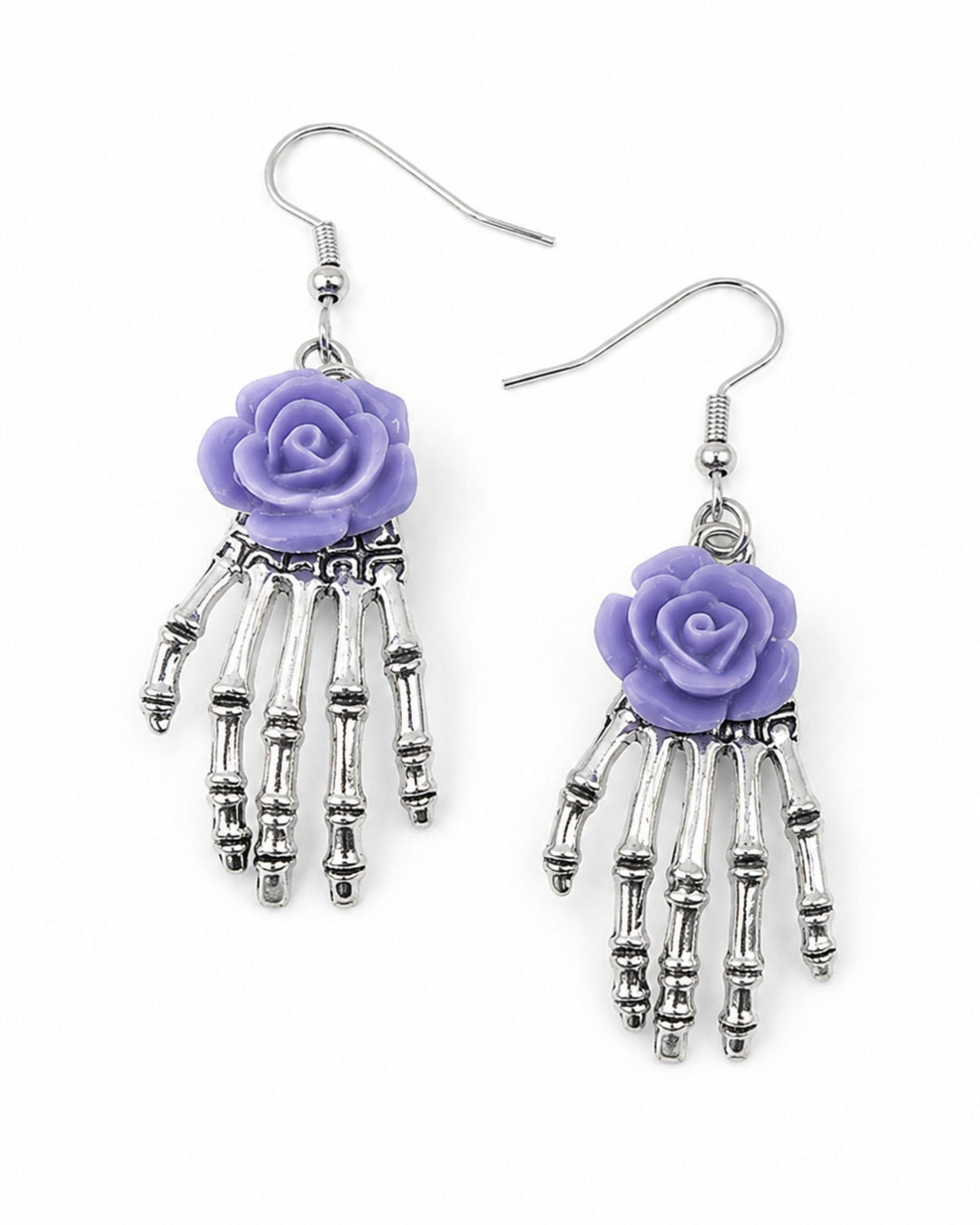 Gothic rose Halloween earrings with dangling silver skeleton hands, purple roses and silver hooks on a white background