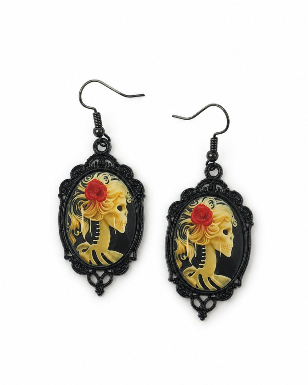 Halloween skeleton cameo earrings with blonde skeleton portraits, red roses, black ornate frames and black hooks on a white background