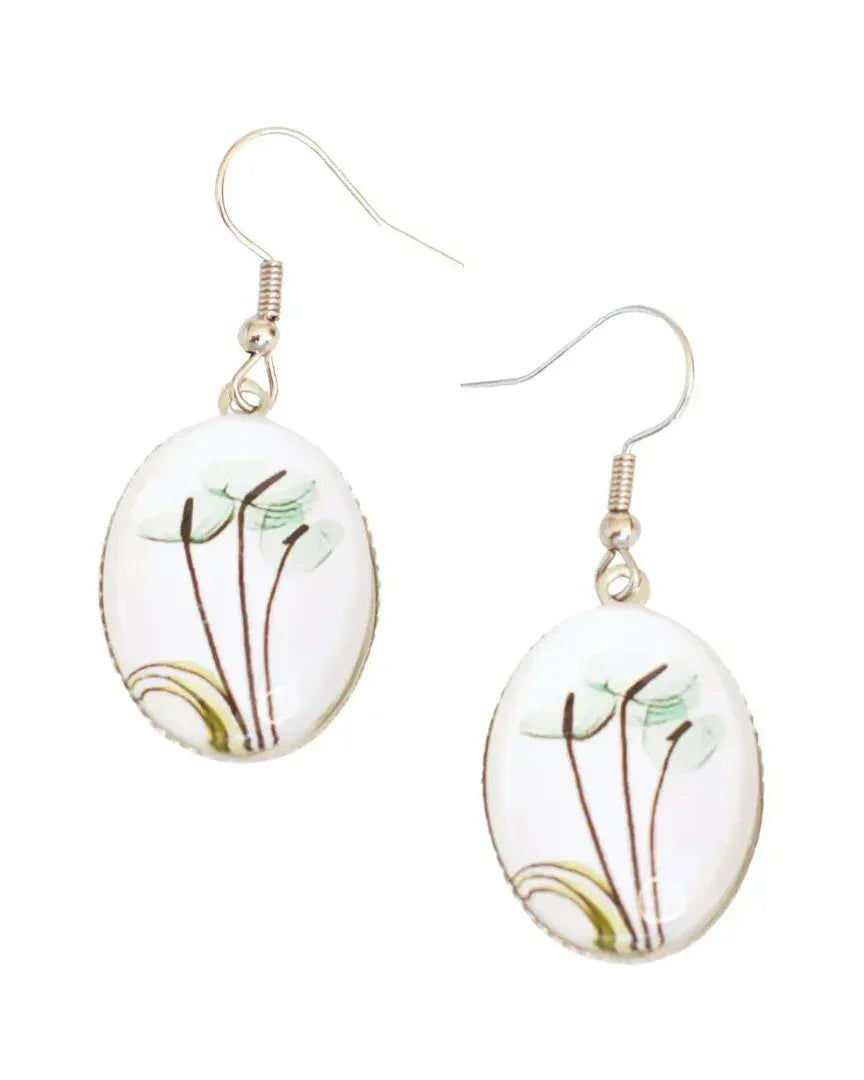 Close-up of green anthurium lily botanical drop earrings with glossy oval glass cabochon