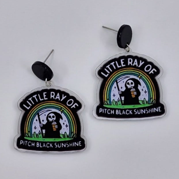 Little Ray of Pitch Black Sunshine Grim Reaper drop earrings in acrylic with rainbow design
