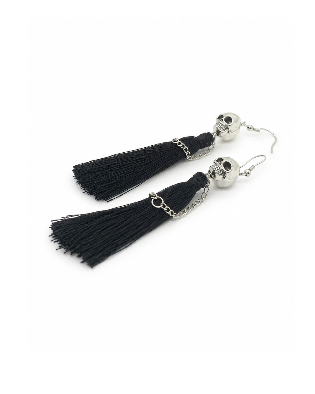 Halloween skull tassel earrings with silver skull charms, black tassels and chain details, laid flat on a white background