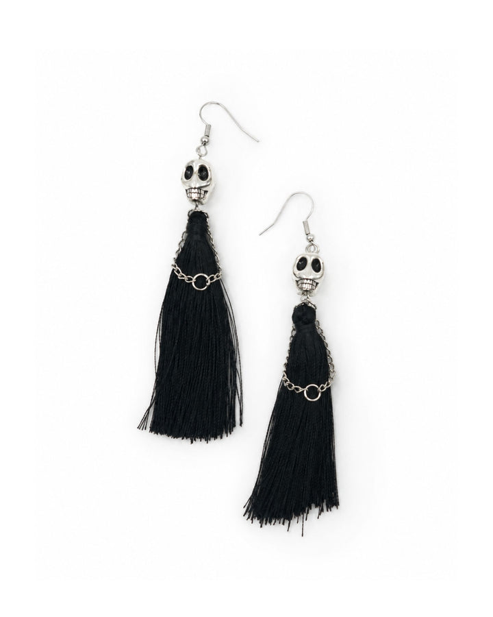 Black Halloween tassel earrings with silver skull charms, long black tassels, chain loops and silver hooks on a white background