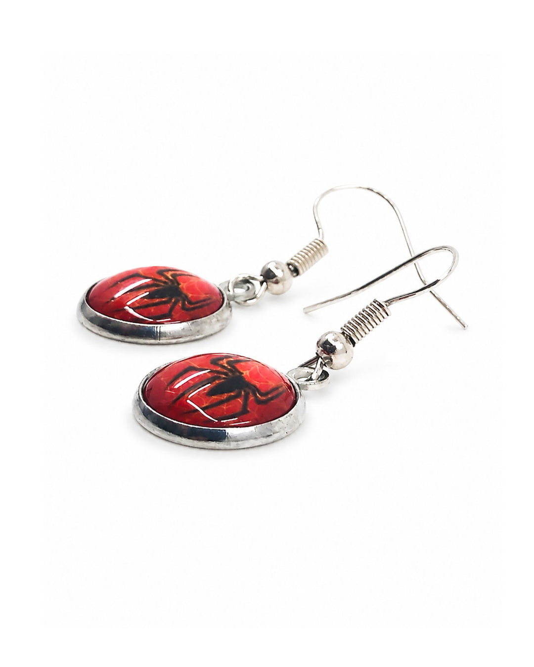 Close-up of Halloween spider drop earrings with red glass cabochon pendants, black spider silhouettes, web detail and silver hooks