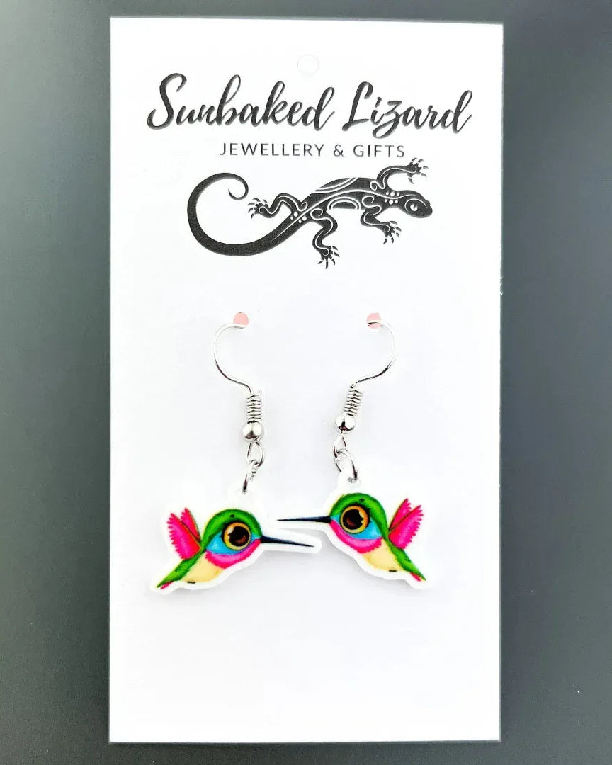Honeyeater drop earrings, a colourful pink, green, and blue bird in flight on silver hooks on a Sunbaked Lizard backing card