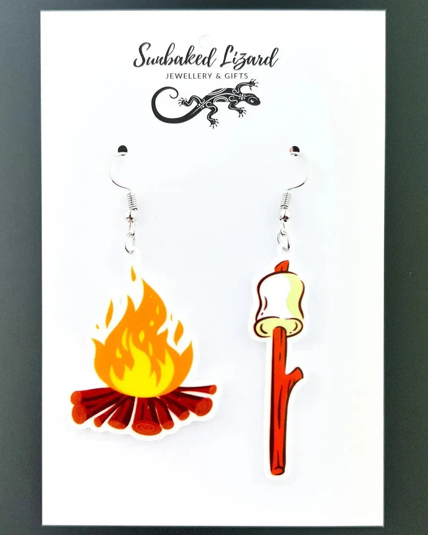 Marshmallows by the Campfire Dangle Earrings displayed on a Sunbaked Lizard branded backing card.