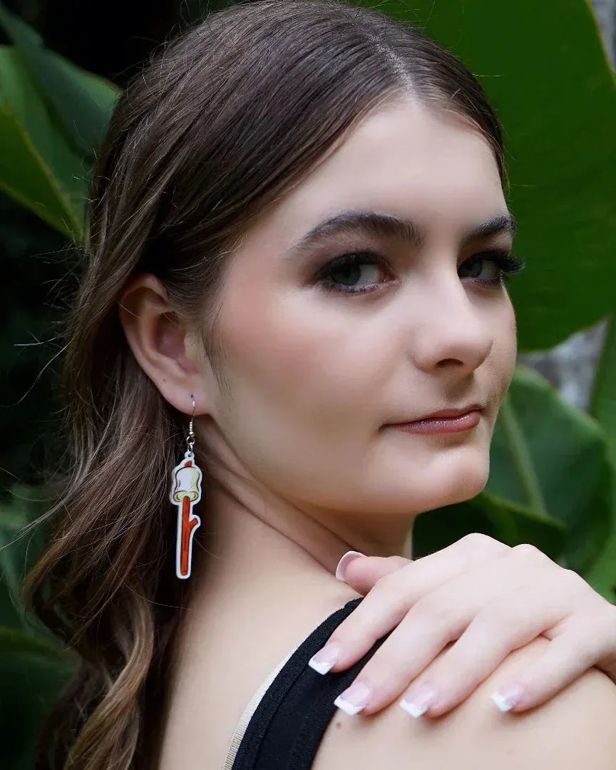 Side view of a model wearing the white marshmallow dangle earring, showing the size and how it hangs.