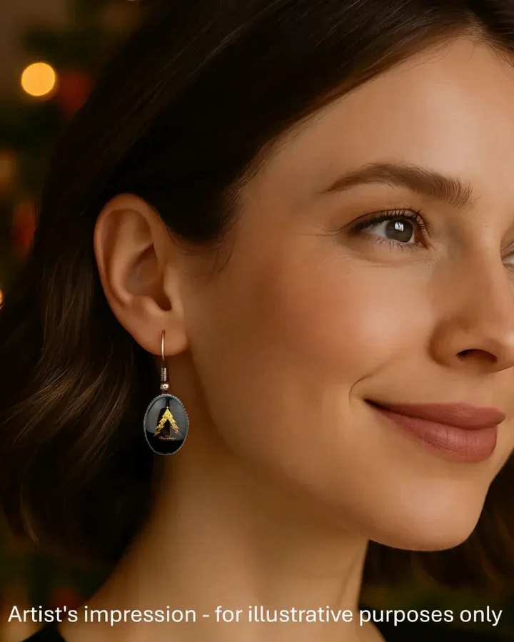 Model wearing a Merry Christmas tree earring, showing the size against her ear