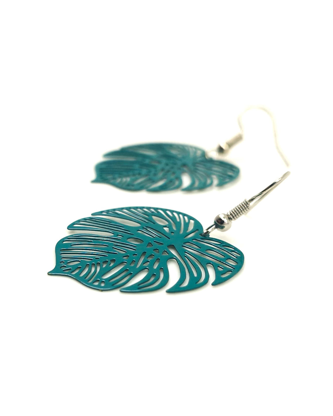 Teal monstera leaf drop earrings with cut-out detail on white background