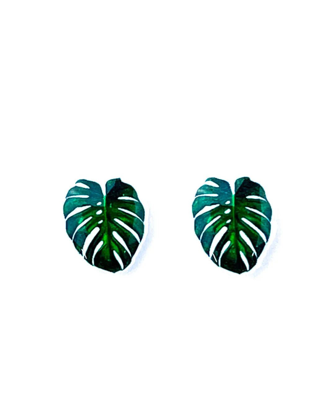 Green monstera leaf stud earrings on Sunbaked Lizard jewellery card with straw background