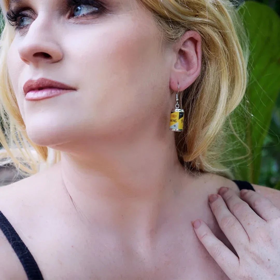 Model wearing rum tin can statement earrings