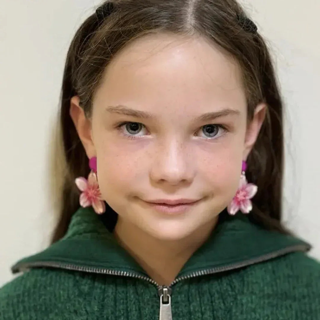 Model wearing bright pink flower stud drop earrings with layered floral design