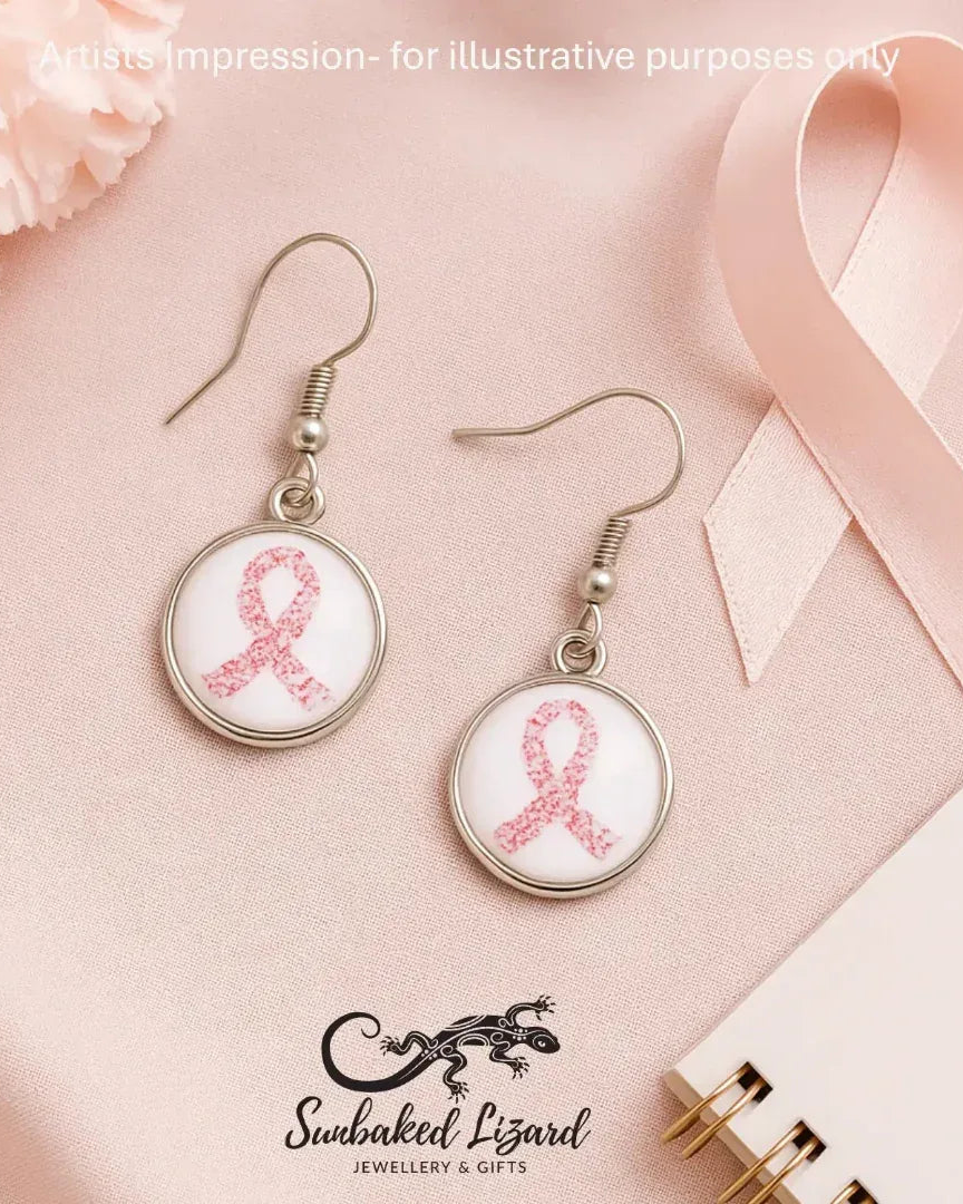Flat lay of pink ribbon glass cabochon earrings for breast cancer awareness