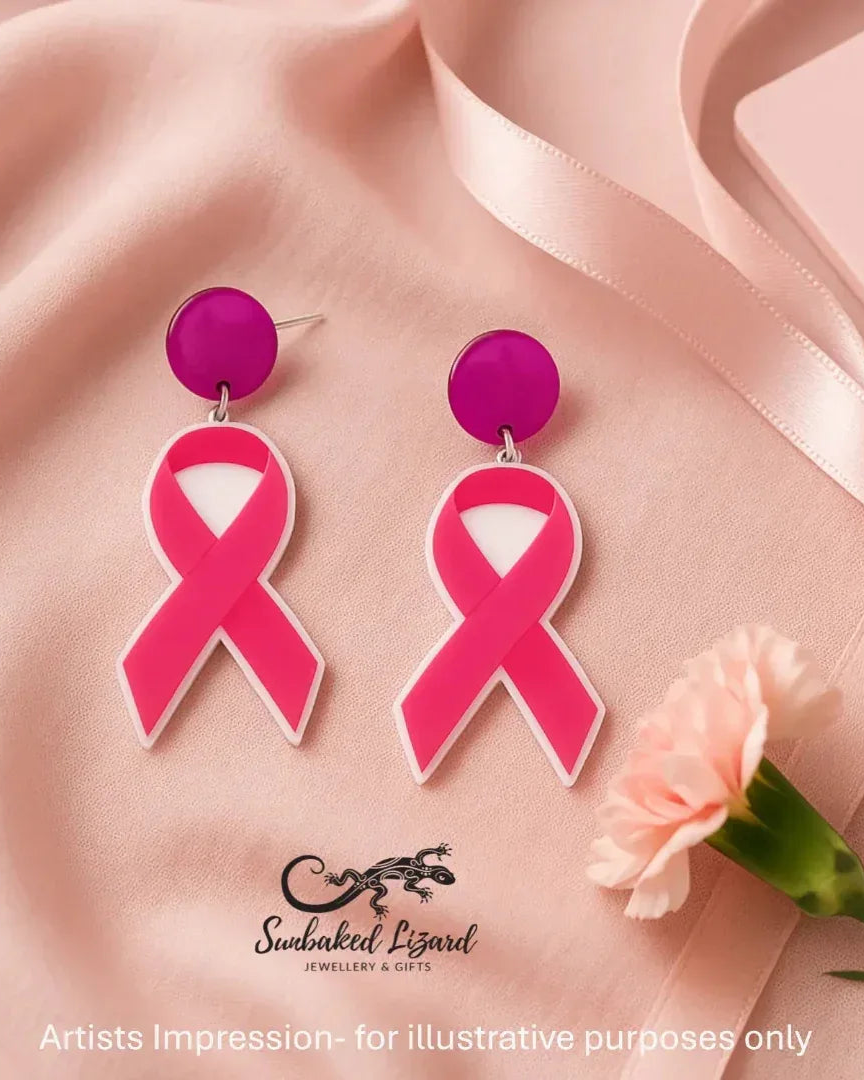 Flat lay of pink ribbon breast cancer awareness earrings in lightweight pink acrylic