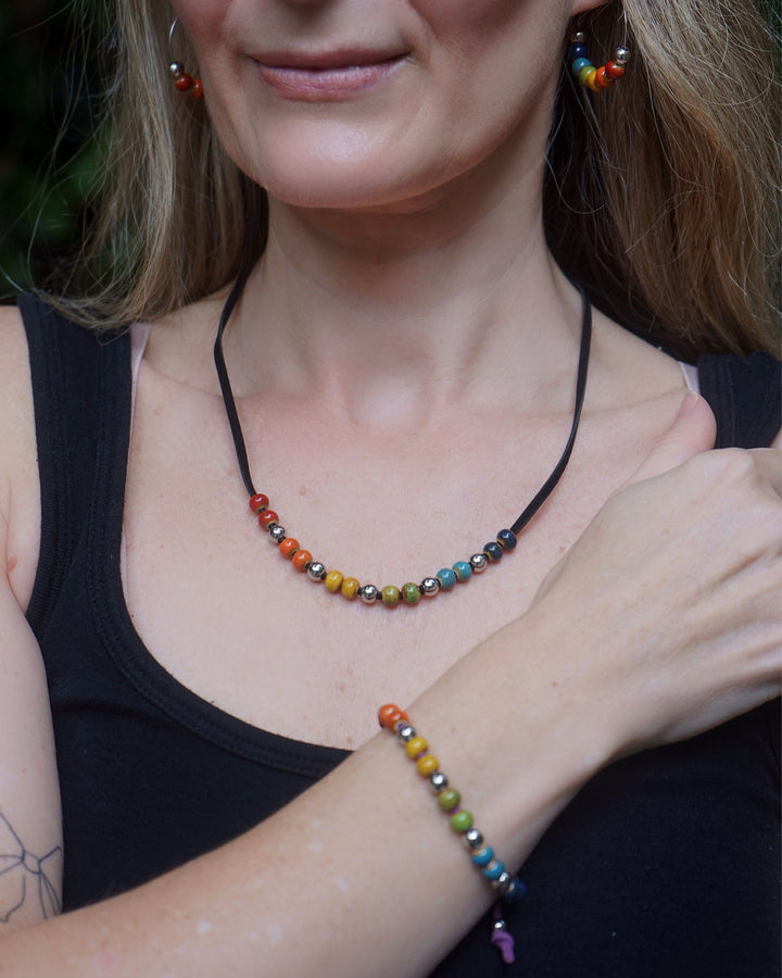 Model wearing Rainbow Pride bracelet with rainbow ceramic beads for Pride and Mardi Gras style