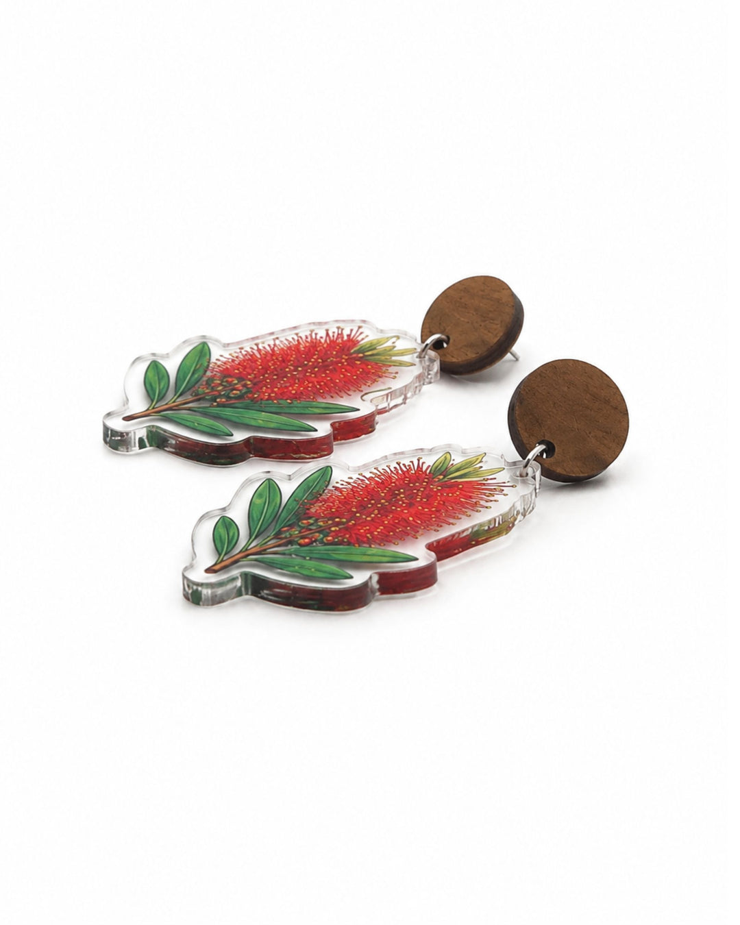 Side view of red bottlebrush earrings showing the flat clear acrylic charm and the wooden stud top