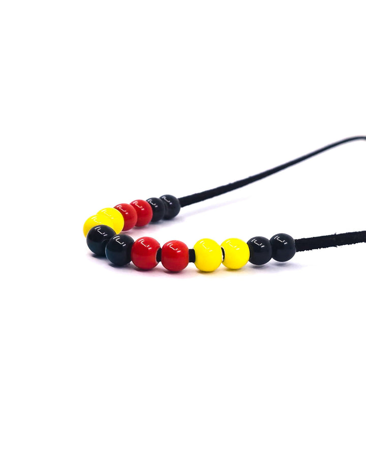 Red, yellow and black Indigenous inspired beaded necklace on black faux leather cord