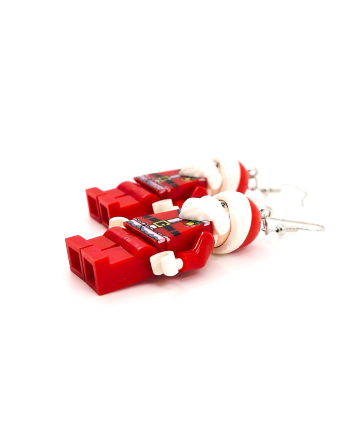 Detail view of block-style Santa Christmas earrings inspired by Lego figures