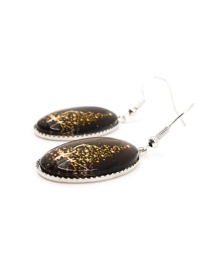 Side view of shimmering Christmas tree earrings showing the domed glass and beaded silver setting