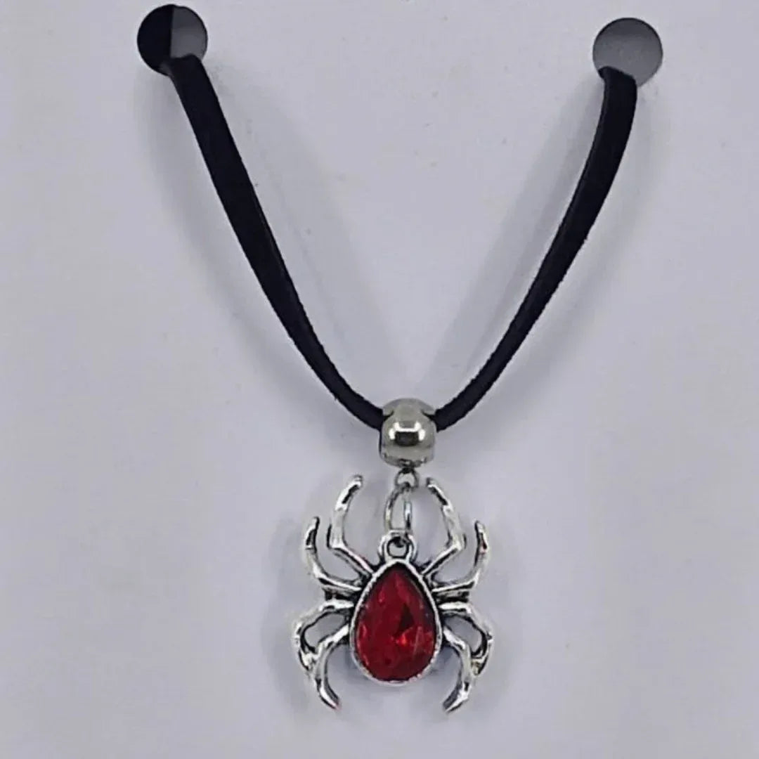 Silver spider pendant necklace with ruby-red gem-style body on black cord – creepy-cute Halloween jewellery