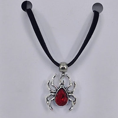 Silver spider pendant necklace with ruby-red gem-style body on black cord – creepy-cute Halloween jewellery
