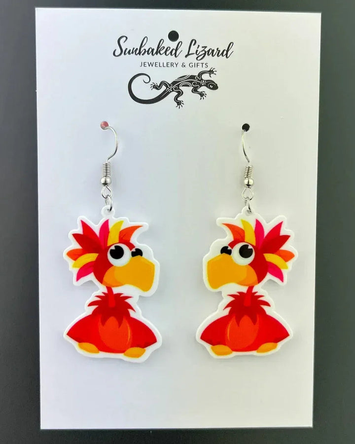 Spike the Parrot drop earrings, red cartoon parrot acrylic charm on silver hooks, on a Sunbaked Lizard backing card