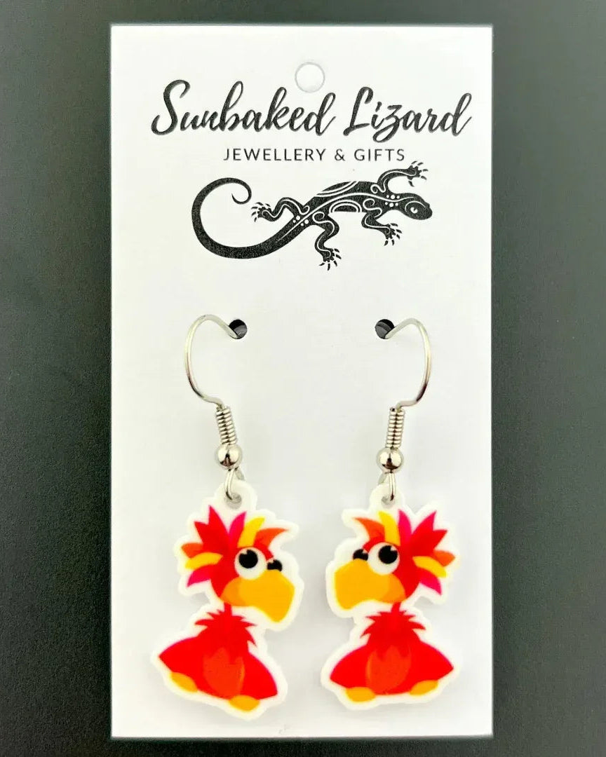 Spike the Parrot drop earrings, red cartoon parrot acrylic charm on silver hooks, on a Sunbaked Lizard backing card