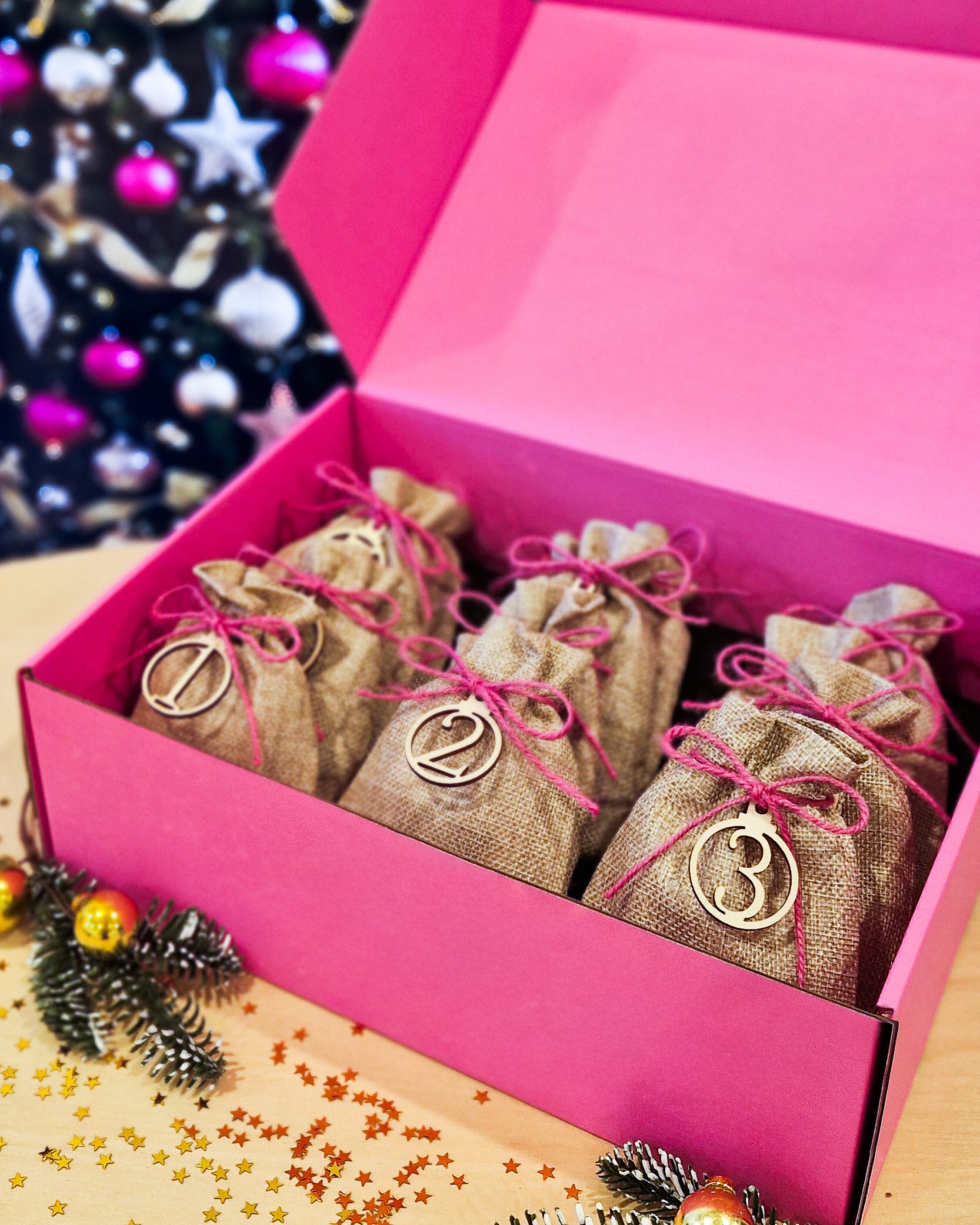 Open Sunbaked Lizard 12 Day Jewellery Advent Calendar showing numbered burlap gift bags inside a pink gift box for Christmas 2026.