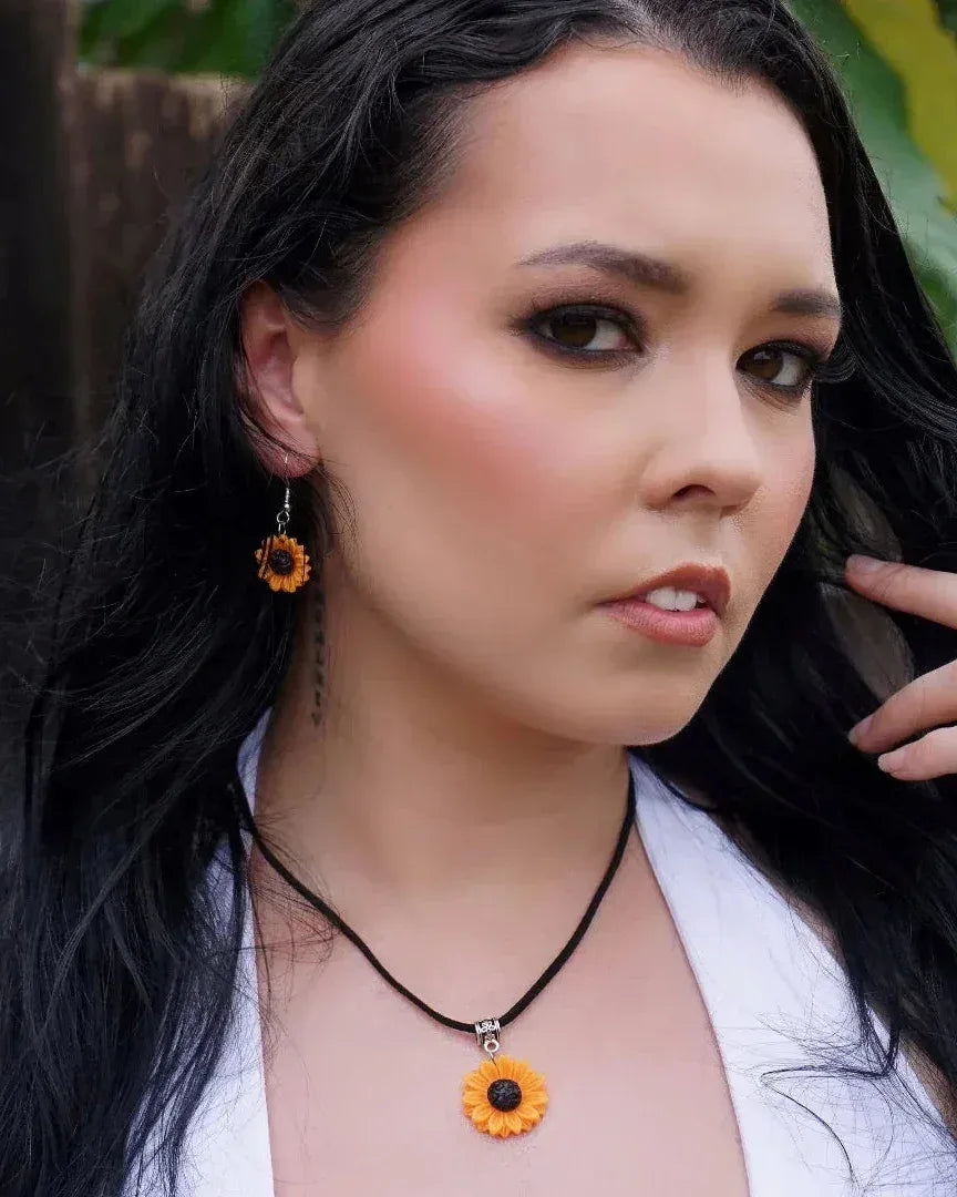 Model wearing sunflower drop earrings and matching sunflower pendant necklace