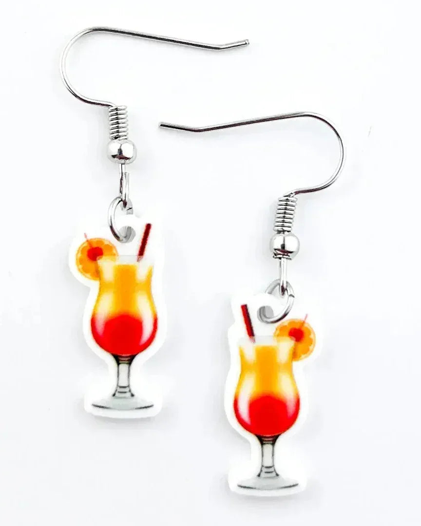 Cocktail earrings featuring a red and orange tequila sunrise drink charm on a white background