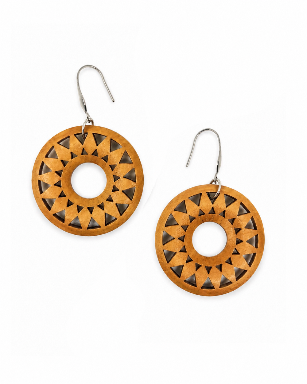 A pair of wooden dangle earrings with a circular design, featuring a geometric cutout pattern of triangles around a central hole, suspended from silver fishhook wires on a plain white background.