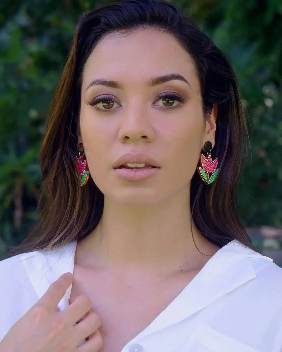 Model wearing pink tulip stud drop earrings with black stud top