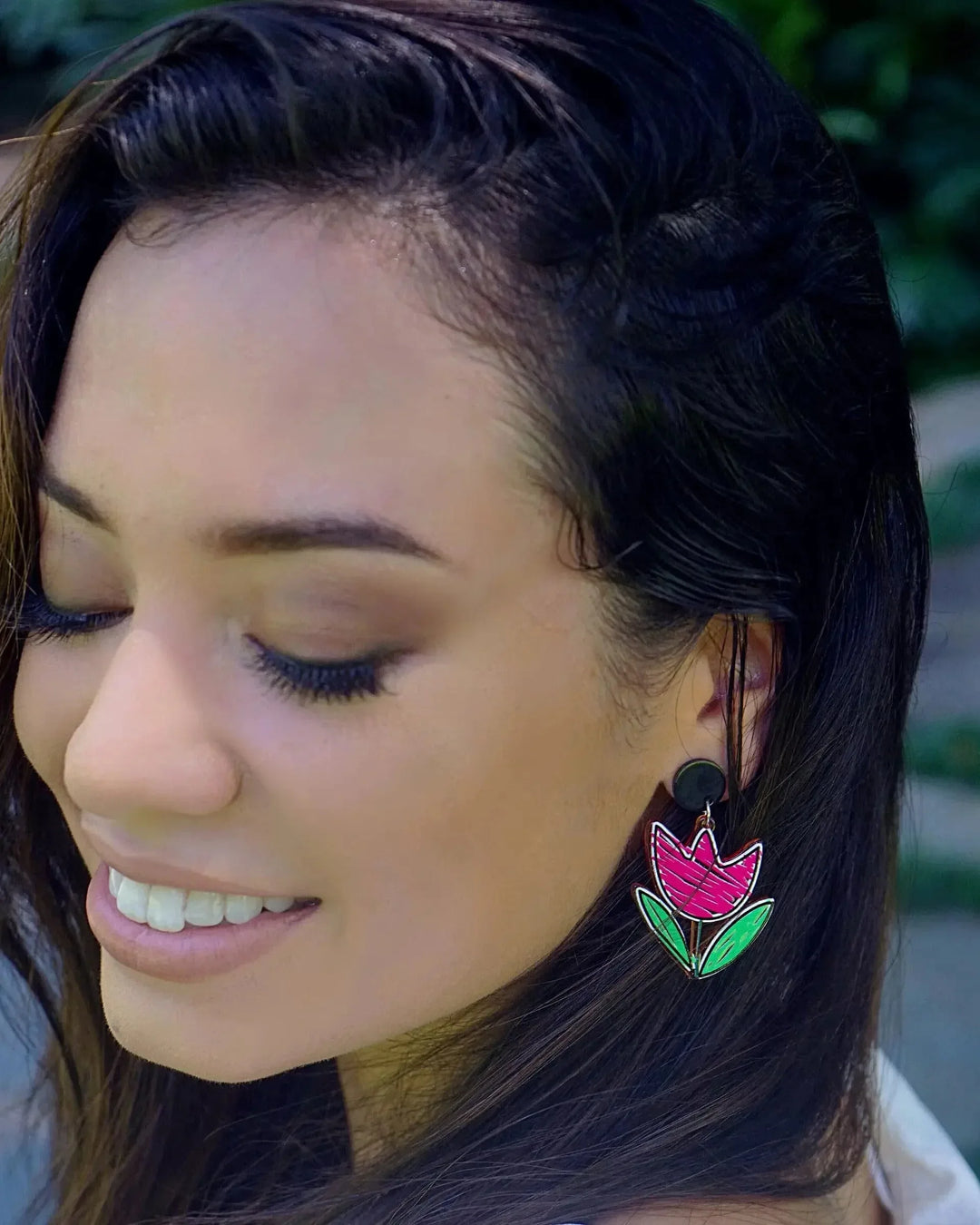 Side view of tulip stud drop earrings in pink and green acrylic