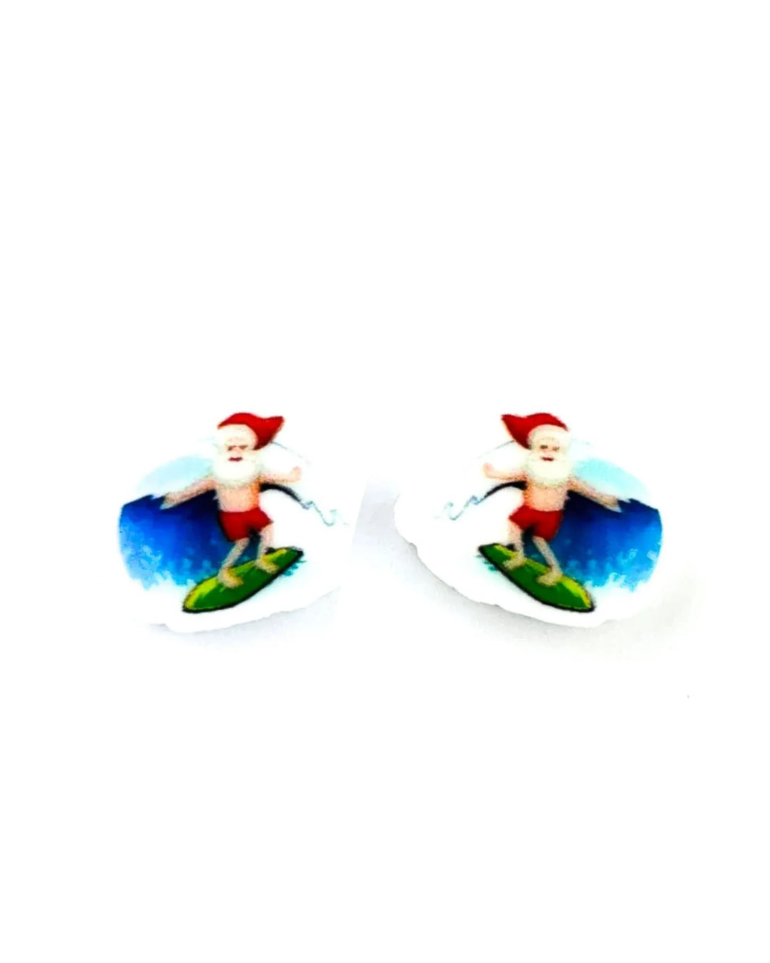 Surfing Santa Christmas stud earrings with Santa in red boardies riding a green surfboard on a blue wave