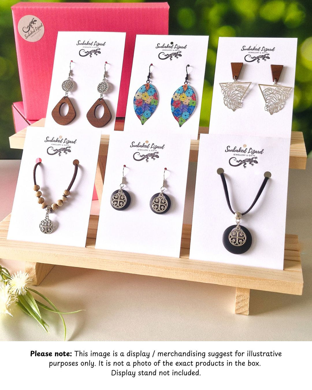 Wholesale fashion and statement earrings displayed on Sunbaked Lizard cards with matching necklace sets and timber display stand
