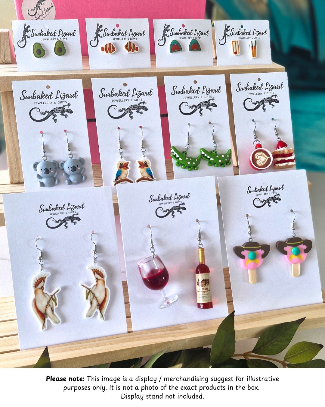 Wholesale fun novelty earrings displayed on Sunbaked Lizard cards with playful food, animal, and colourful designs on timber display stand