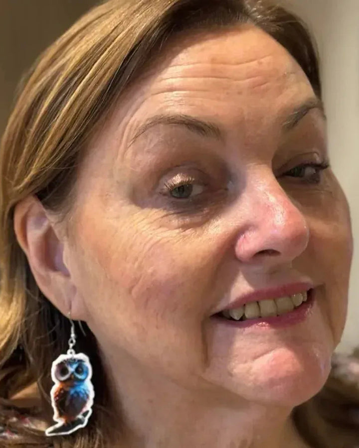 Side view of a Wise Owl drop earring worn on the ear, showing the length of the drop