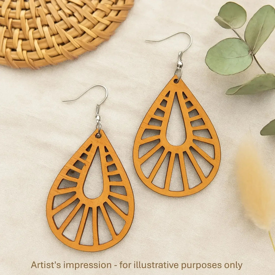 Close up of lightweight timber teardrop earrings with radiating cut-out pattern