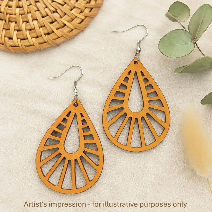 Close up of lightweight timber teardrop earrings with radiating cut-out pattern