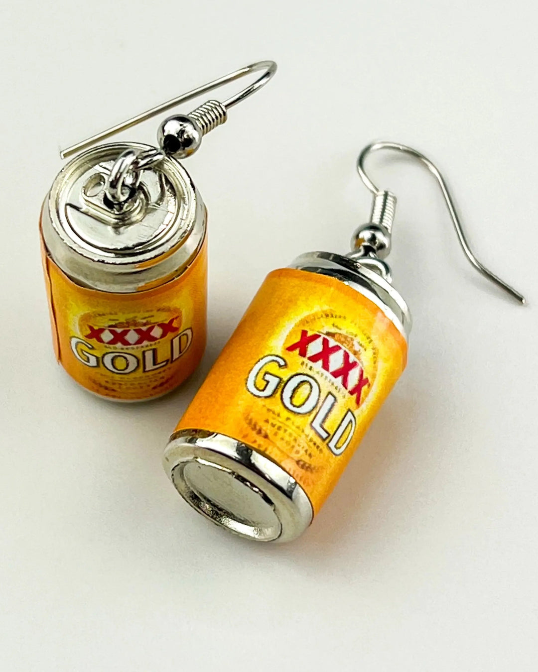XXXX Gold beer can dangle earrings with gold label and silver pull tab detail on white background