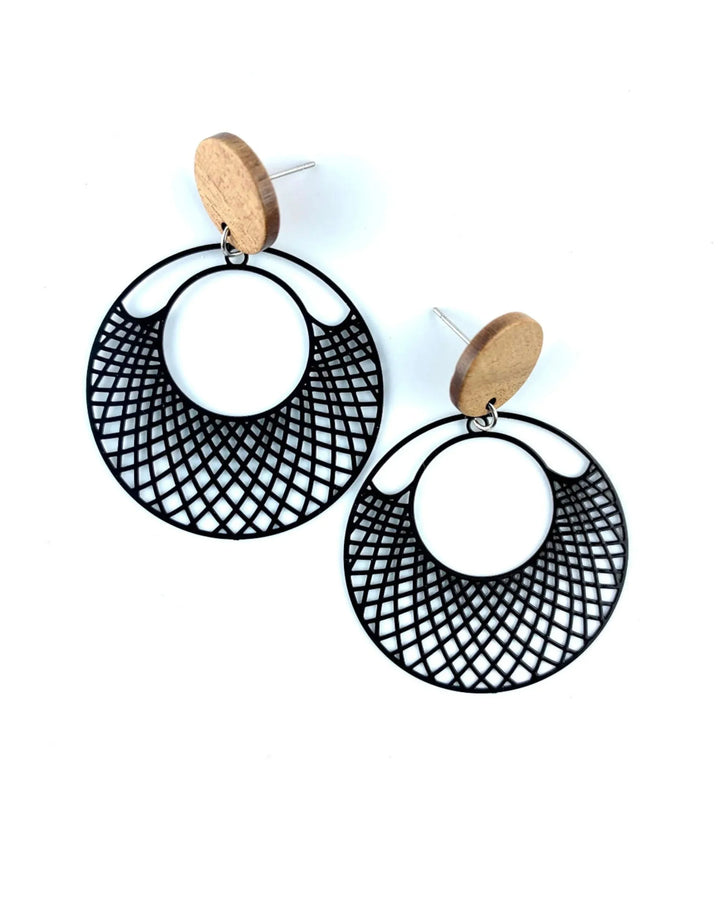 Black filigree round earrings with timber stud top and cut-out lattice circle drop on white background