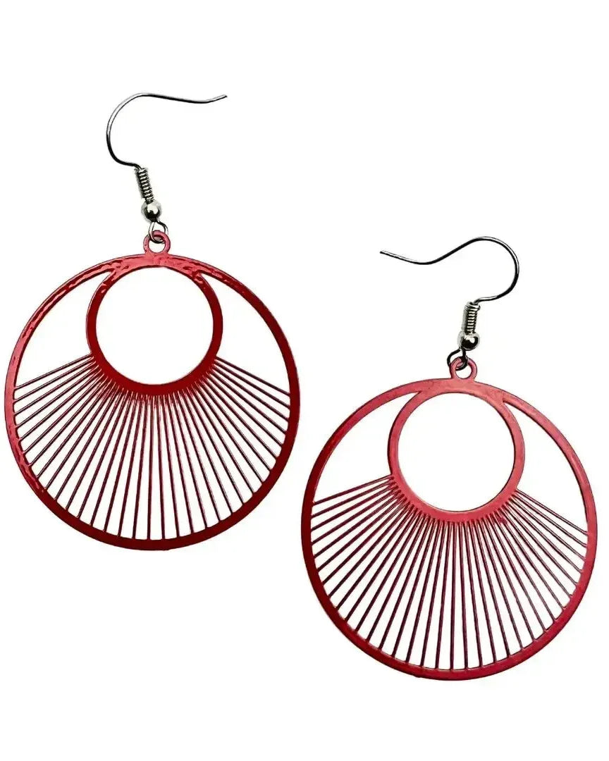Red filigree round lined dangle earrings with radiating line detail and silver hooks on white background