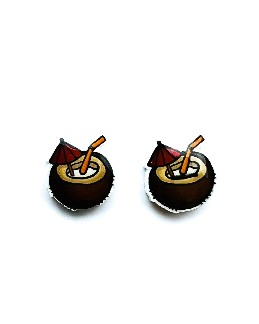 Alcohol stud earrings showing the tiny red umbrella and toasted brown coconut shell detail.