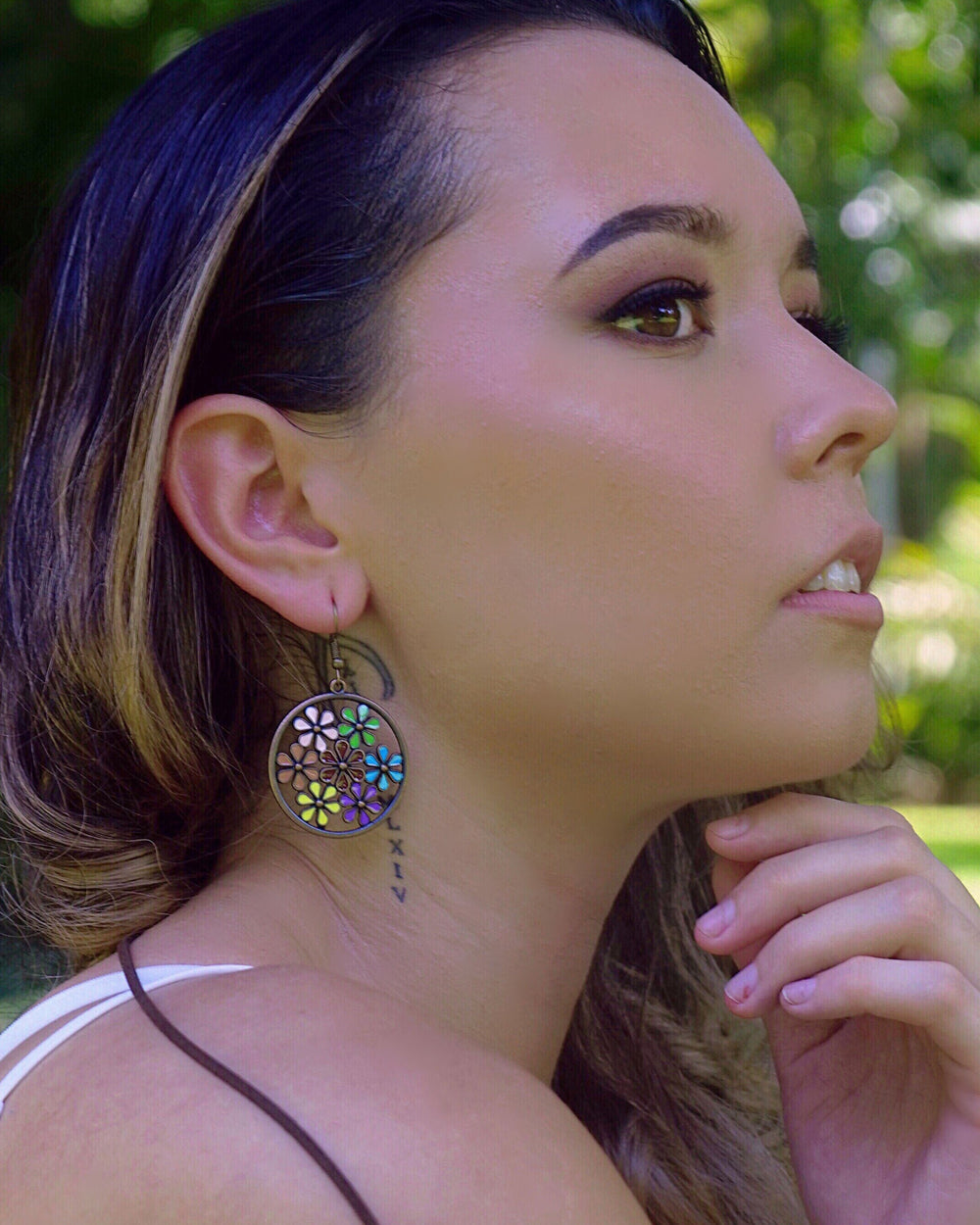 Model wearing copper floral earrings with a casual boho outfit