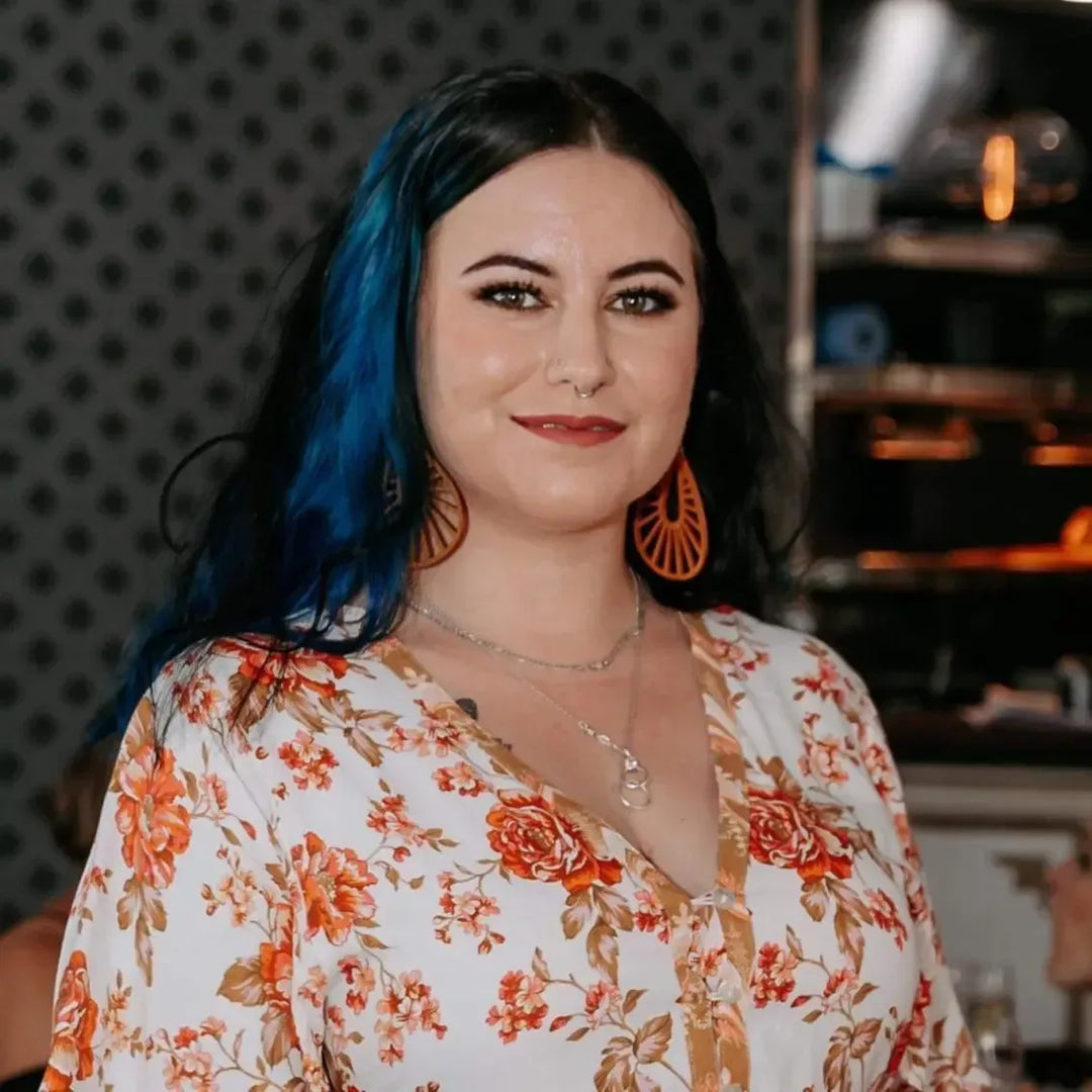 Large boho style wooden teardrop earrings worn by a woman