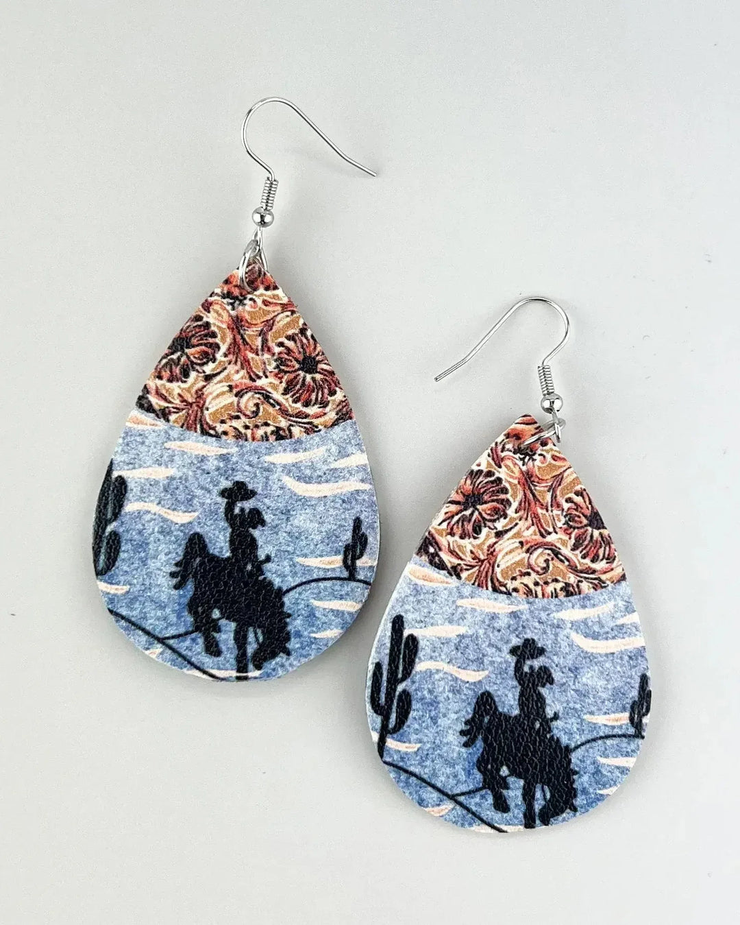 Cowboy print leather drop earrings with vintage paisley and desert silhouette designs in a teardrop shape