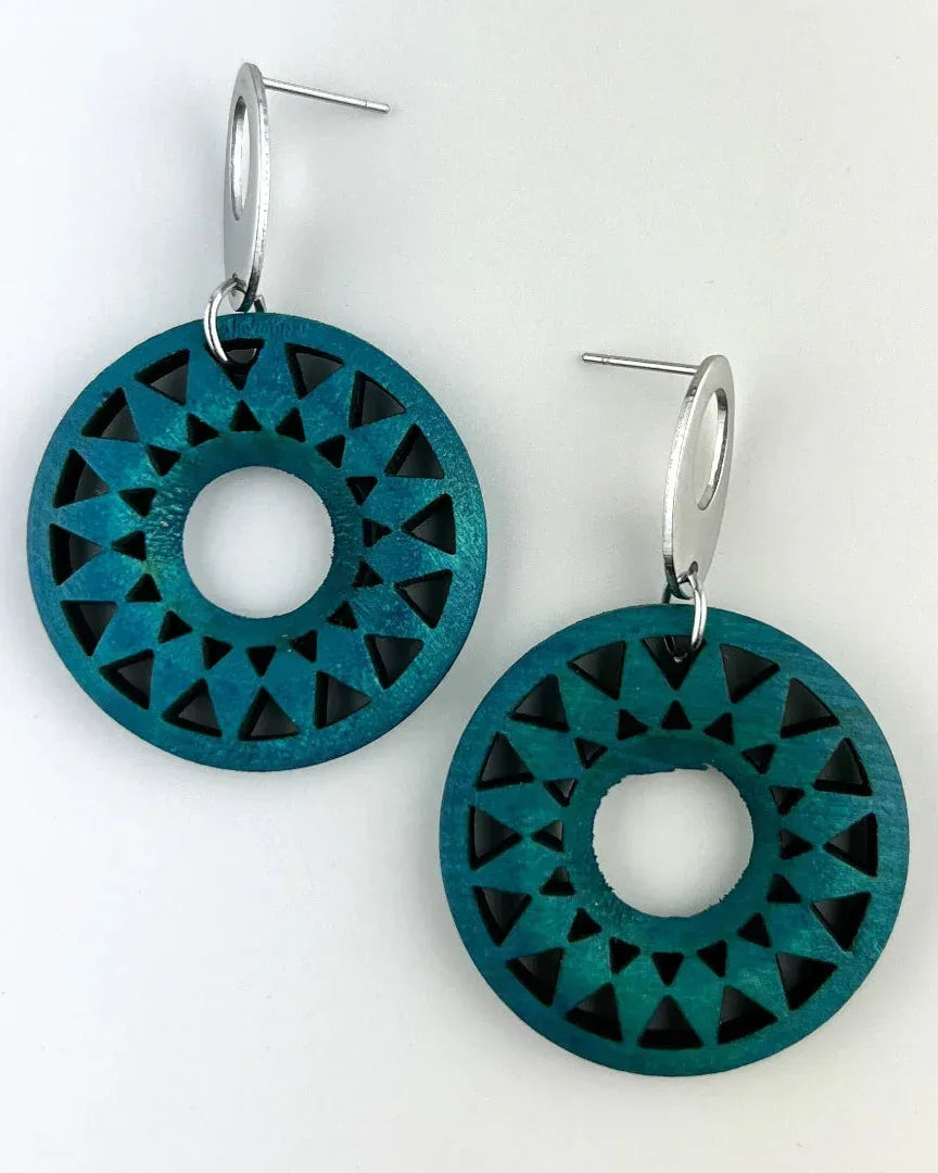 Dark teal timber sun earrings with geometric cut-out pattern attached to silver oval studs