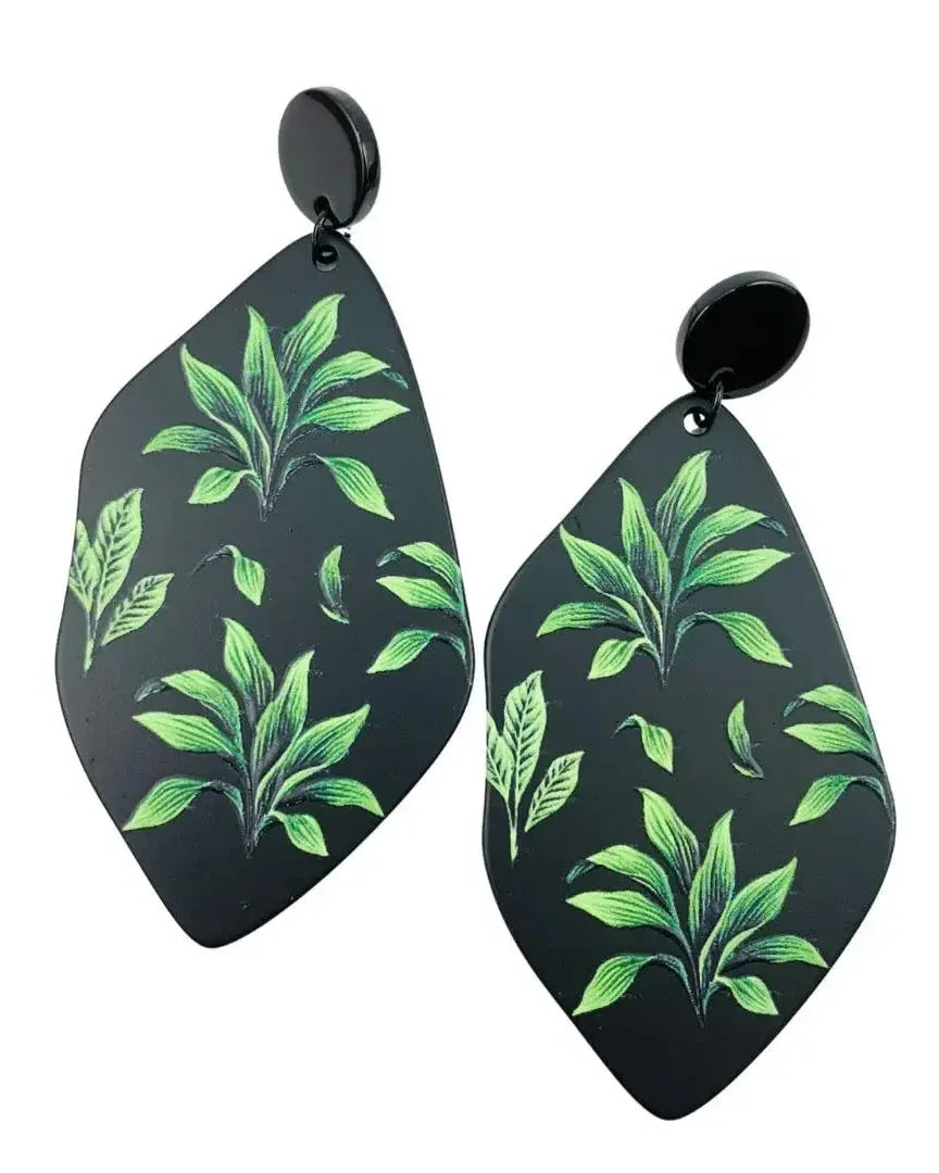 Fern tropical plant drop earrings product photo on white background